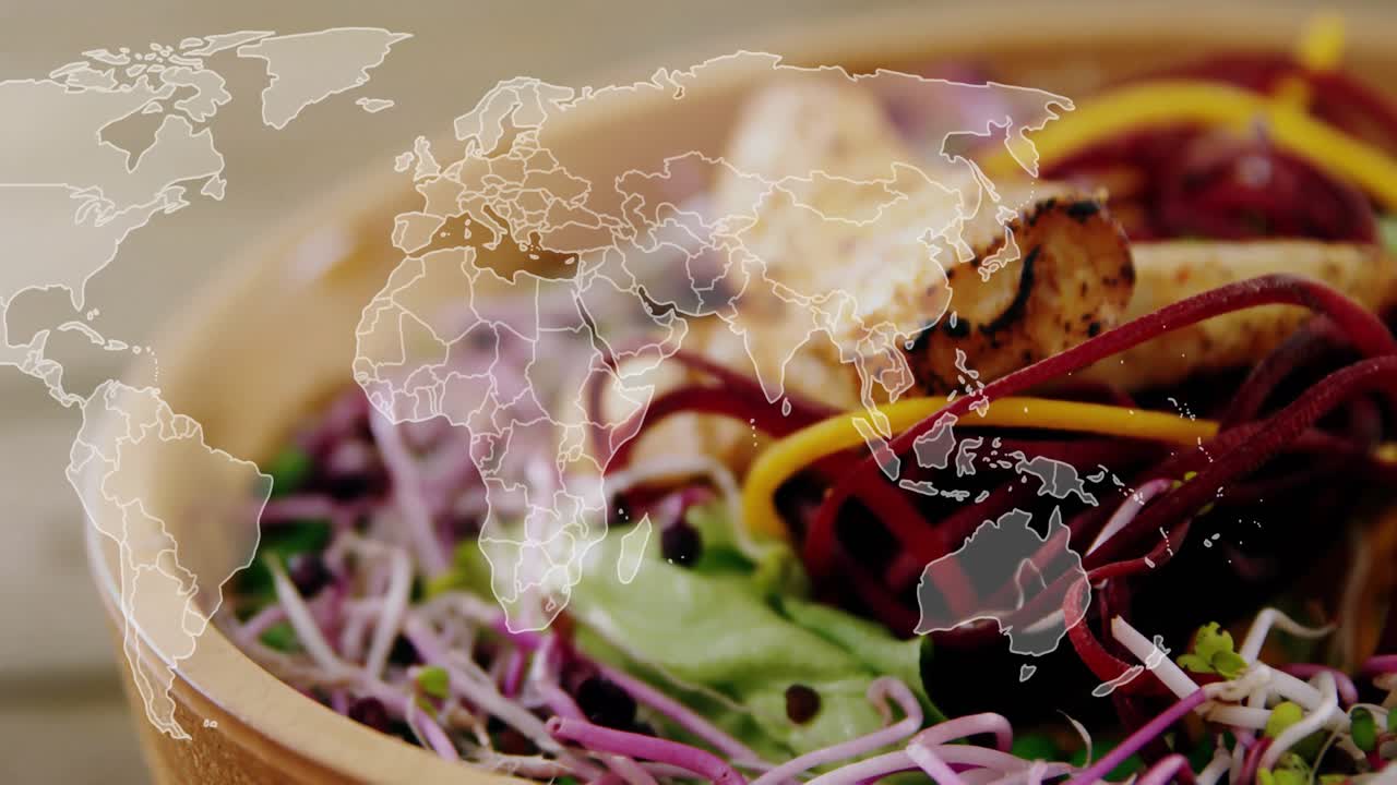 Efter en pause fader et verdenskort-overlay ud og pulserer over en salatskål, der fremhæver globale smagsoplevelser.