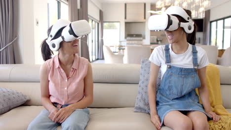 wearing vr headsets, two teenage girls hanging out and smiling on couch