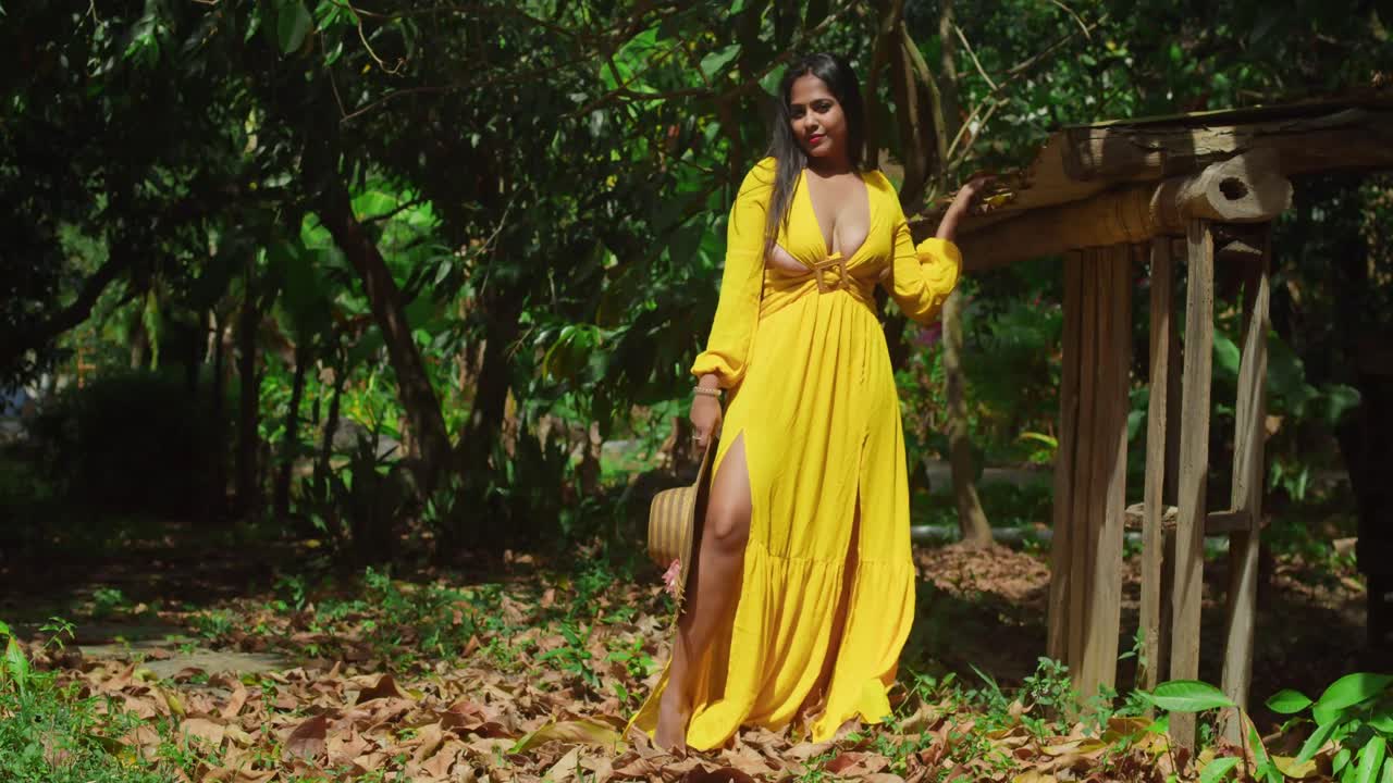 Woman in yellow dress in a tropical forest