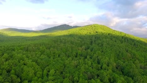 Aerial-wide-shot-at-Dawn-of-lush-green-mountain-and-purple-skies-in-the-Shenandoah-Valley,-part-of-the-Blue-Ridge-Mountain-chain-in-Virginia