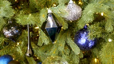 close up of a decorated christmas tree adorned with ornaments and blinking lights