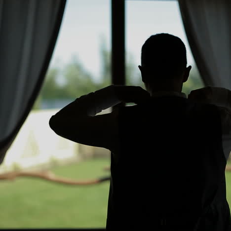Man in a white shirt dresses trendy jacket. Window in the background. Square video