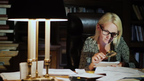 Woman-Examines-Document-With-Magnifying-Glass