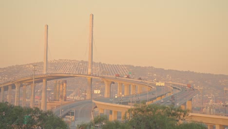 a bridge with sweeping cables at sunset, scenic and calm california evening