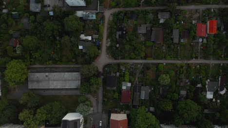 Aerial-birds-eye-overhead-top-down-panning-view-of-low-houses-in-Ruegen-allotment-gardens.-Berlin,-Germany