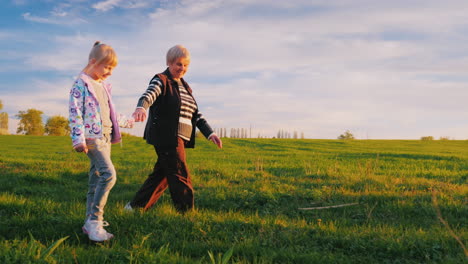 grandmother and granddaughter are walking around the countryside