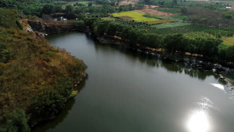 aerial view of a rural landscape with lake and farmland