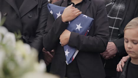 funeral, cemetery and woman with american flag