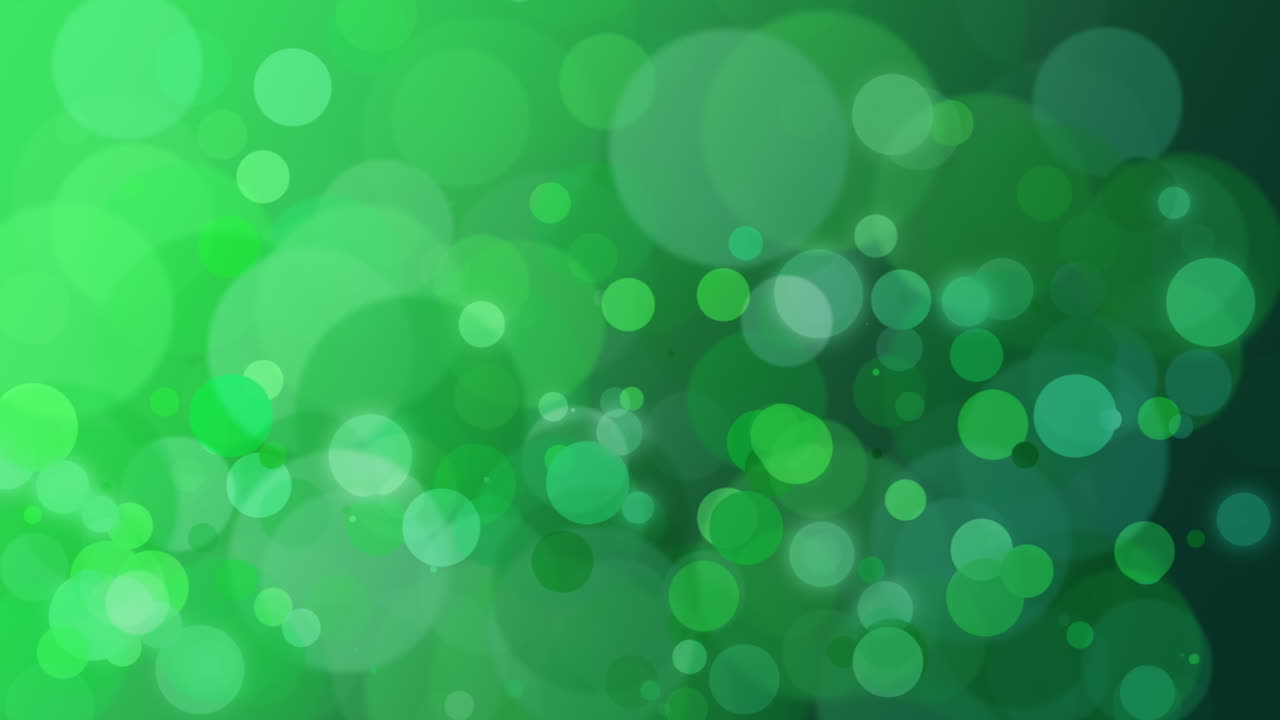 Abstrakt grøn bokeh og faldende partikler med