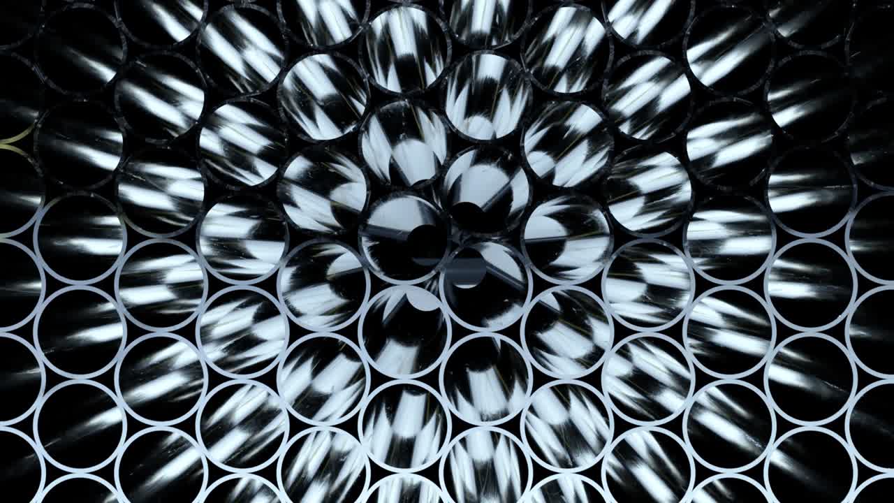 Rows of Metal Pipes with reflections and Sun Flares inside. Steel pipes at metal factory.