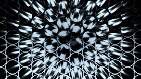 rows of metal pipes with reflections and sun flares inside. steel pipes at metal factory.