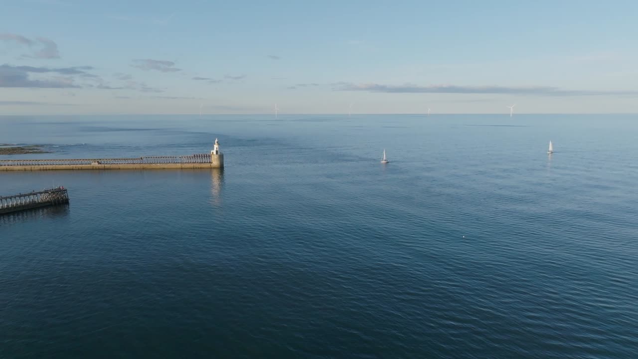 Drone clip of two sailboats on calm summer day off the Northumberland coast