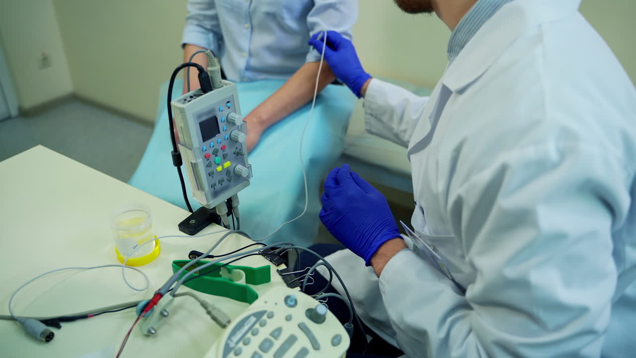Doctor Testing Female Reflexes. Male doctor performing neurological tests on female patient