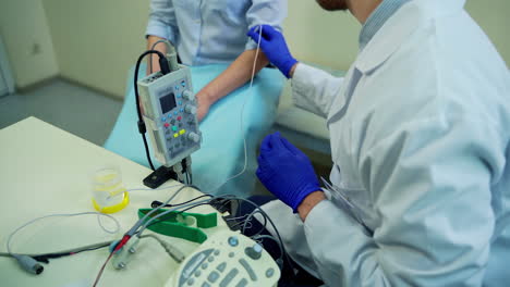 doctor testing female reflexes. male doctor performing neurological tests on female patient