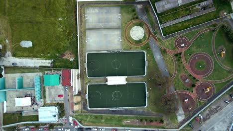 panoramic overhead view of the design of a recreational park with basketball and 5-a-side soccer courts and exercise swings in a small town