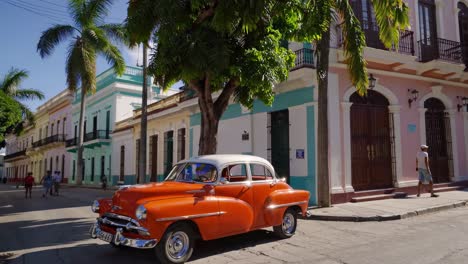 vintage car in a colorful cuban street scene