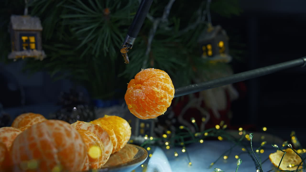 Robotic equipment for peeling tangerines. Fresh mandarin on plate for New Year celebration. Modern technology for Christmas.