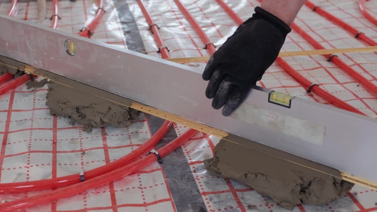 Installing underfloor heating pipes for water heating. Heating systems. Pipes for a heat-insulated floor.