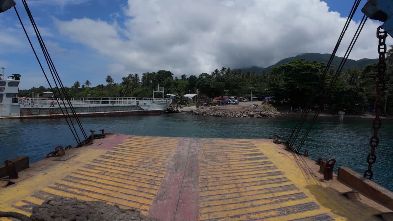 Point-of-view footage capturing a ferry barge docking at the San Ricardo port on Panaon Island in the Philippines, showing a realistic view of the docking process from the vessel's perspective.