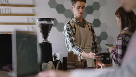 happy businessman cashier working in busy cafe barista serving customers buying coffee using credit card supporting small business enjoying friendly service successful startup shop