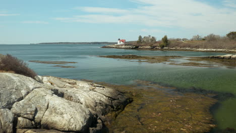 Low-Angle-Aerial-of-Hendrick's-Head-Lighthouse-in-Southport,-Maine,-USA