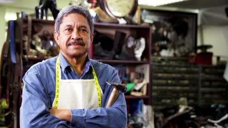 Portrait-of-shoemaker-standing-with-arms-crossed