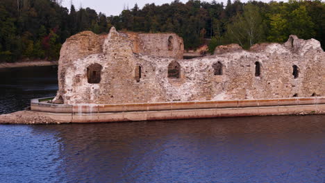 aerial close up of koknese castle ruin complex in koknese, latvia, on the daugava river valley drone footage at sunset