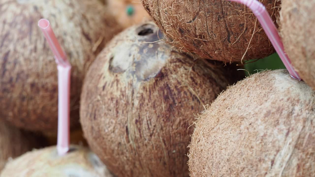 Coconuts with straws for drinking