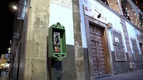 old green telephone box in downtown