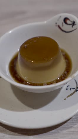 eating a delicious caramel pudding