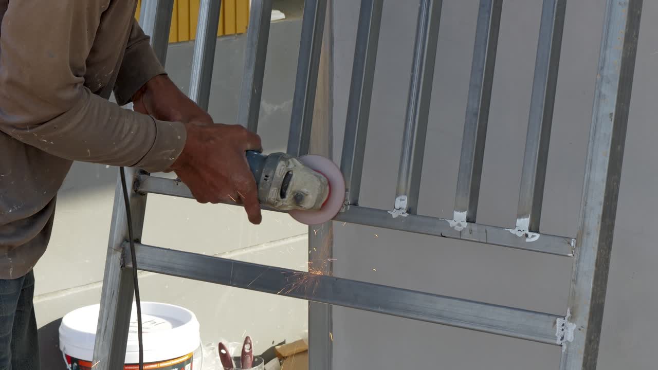 A worker expertly installs metal fencing showcasing precision and skill in construction