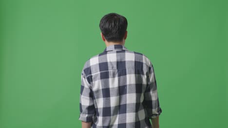 back view of asian man walking in green screen background