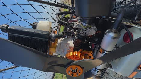 vertical format: closeup detail view of paramotor engine and propeller