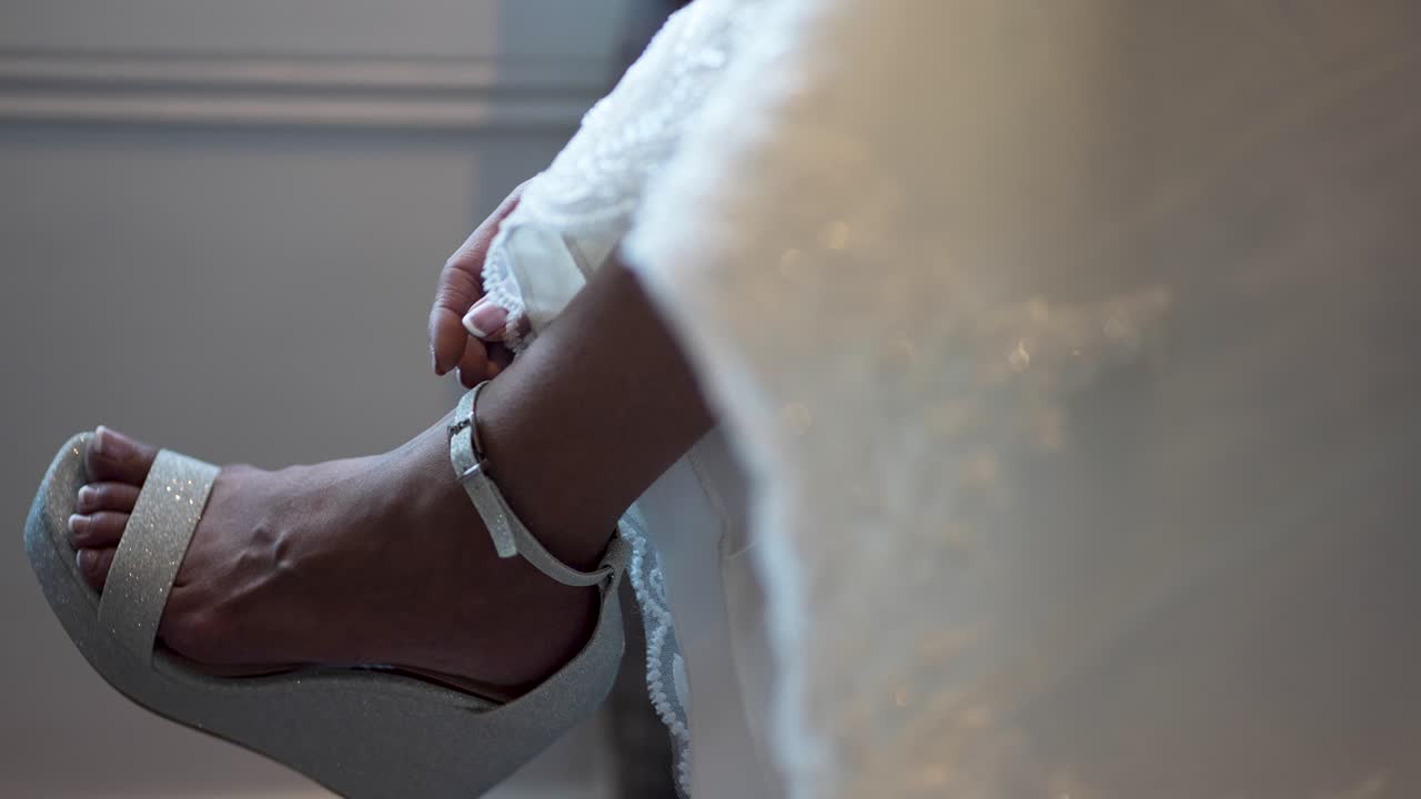 The Western bride is elegantly attired for the event, wearing stunning heels on her feet
