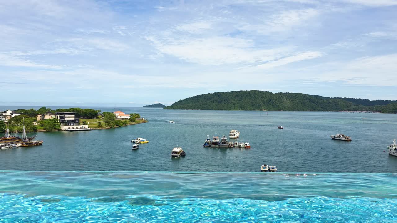 Boats In The Ocean Seen From Infinity Pool Of Kota Kinabalu Marriott Hotel In Kota Kinabalu, Sabah, Malaysia. - wide shot