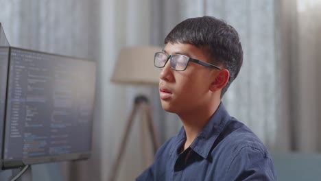 young man coding on a computer