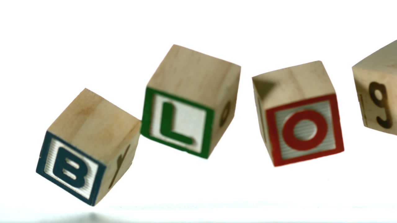 Row of blocks spelling Blog falling over 