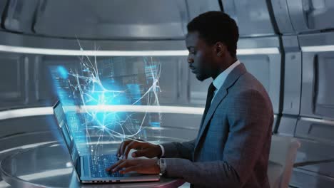 man working on a futuristic laptop with a holographic display