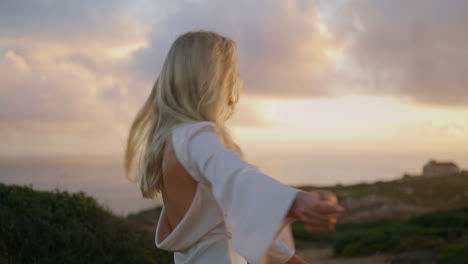 relaxed woman enjoying sunset portrait. flying hair girl turning around posing