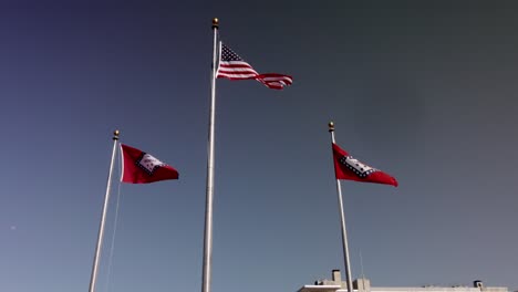 American-flag-and-two-Arkansas-state-flags-flying-outside-of-Arkansas-state-capitol-building-in-Little-Rock,-Arkansas-with-stable-video