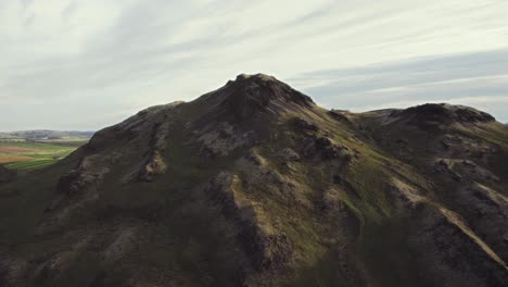 aerial grass mossy green mountain top, iceland during golden warm evening sunset in summer