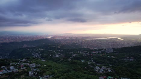overlooking taipei, taiwan from a mountain during dramatic cloudy sunset - drone forward push