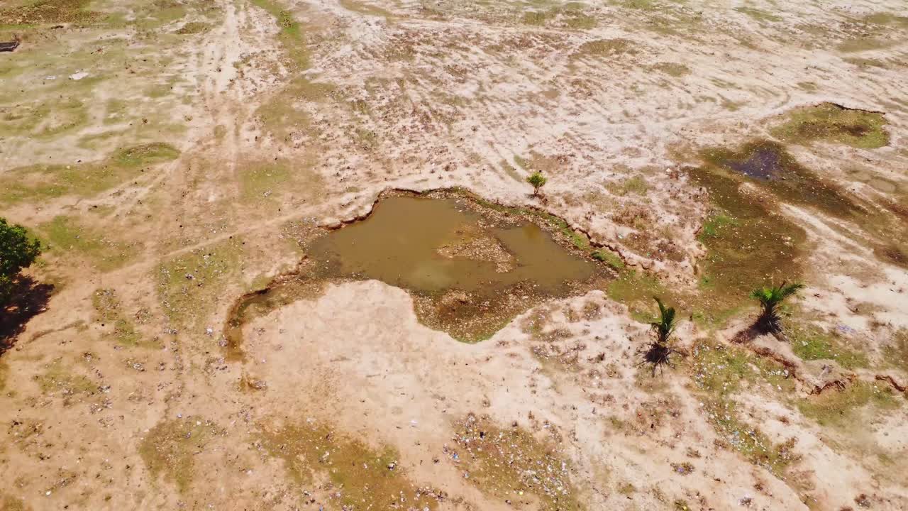 Aerial of a small pond in a beautiful landscape in rural Nigeria, Africa on a sunny day