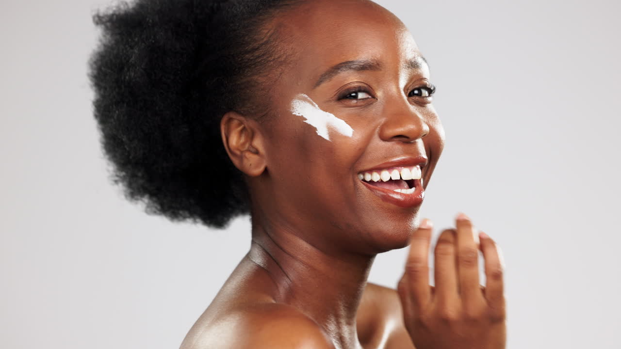 Face, skincare and happy black woman with cream