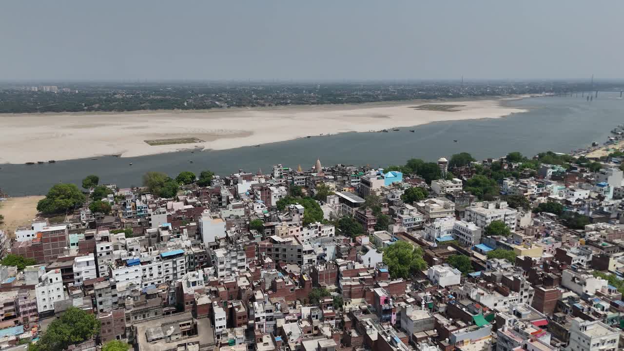 Scenic drone shot capturing the vibrant life of Varanasi, where the ancient cityscape is crisscrossed by bustling lanes and the timeless flow of the Ganges.