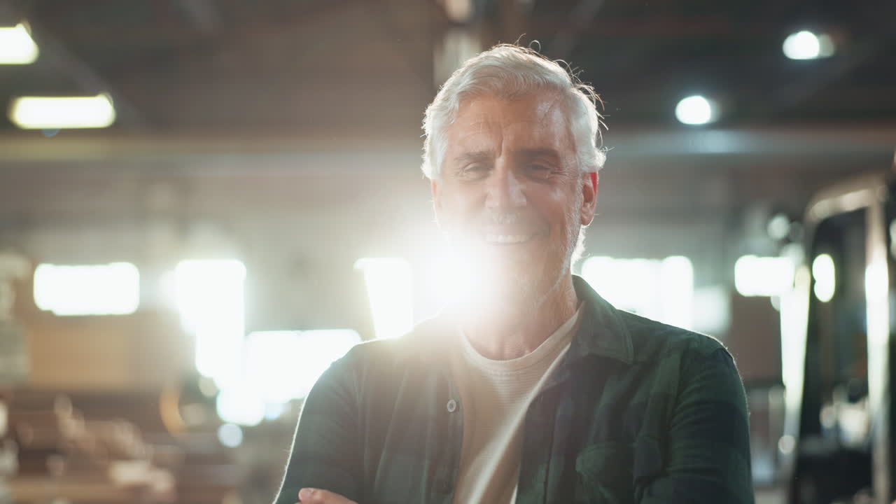 Portrait of a smiling older man in a workshop