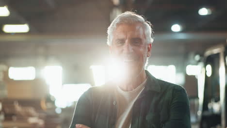 portrait of a smiling older man in a workshop
