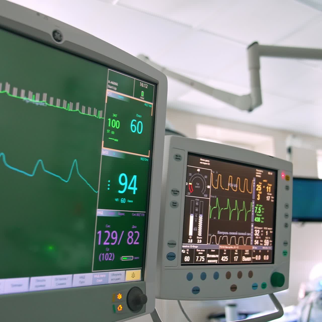Monitors working in the surgery room during surgical operation. Close up. Surgeon working at the backdrop near Da Vinci robot