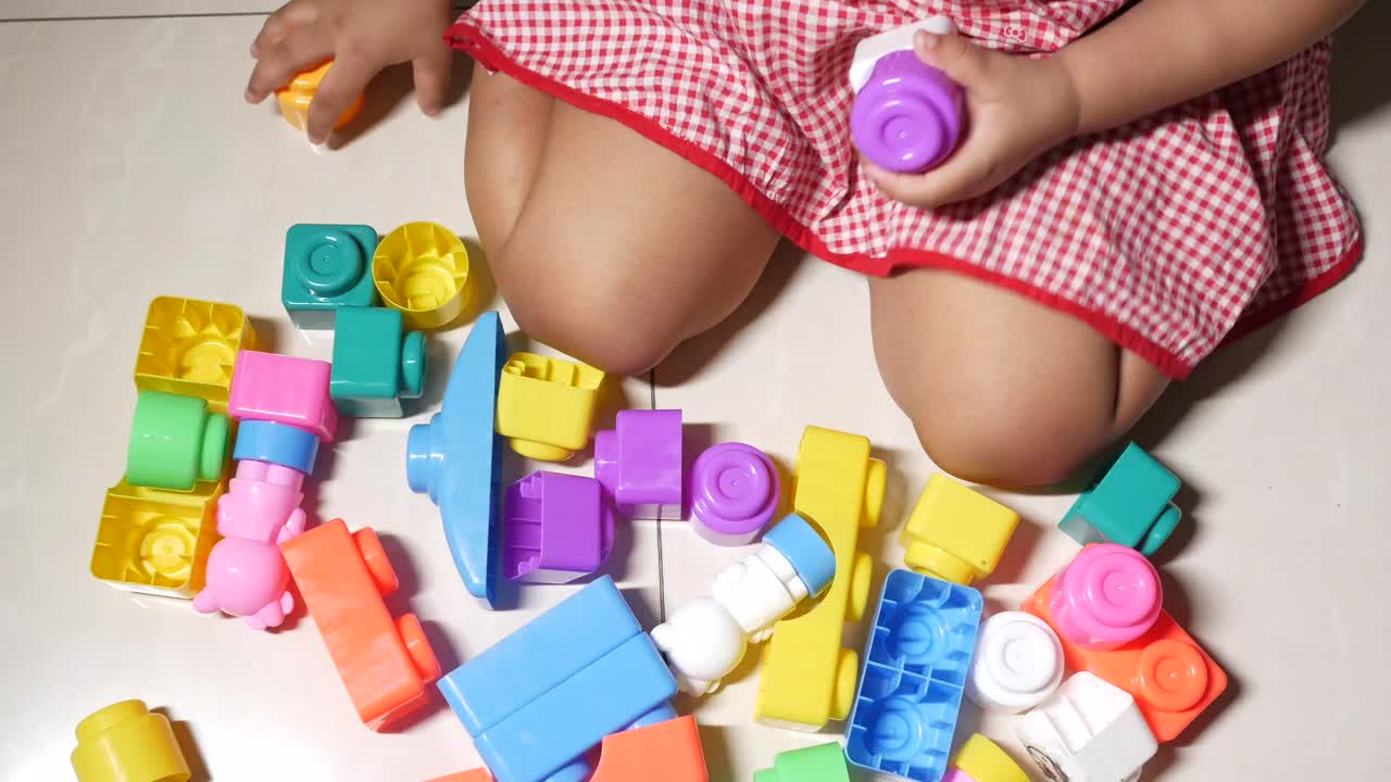 Child playing with colorful building blocks