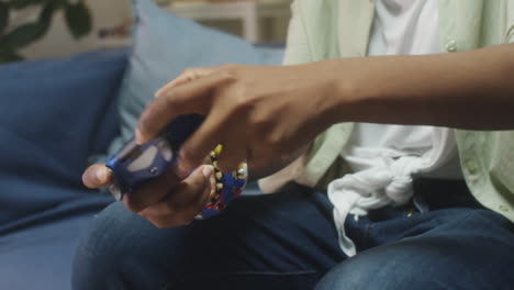 young african american woman playing video games at home